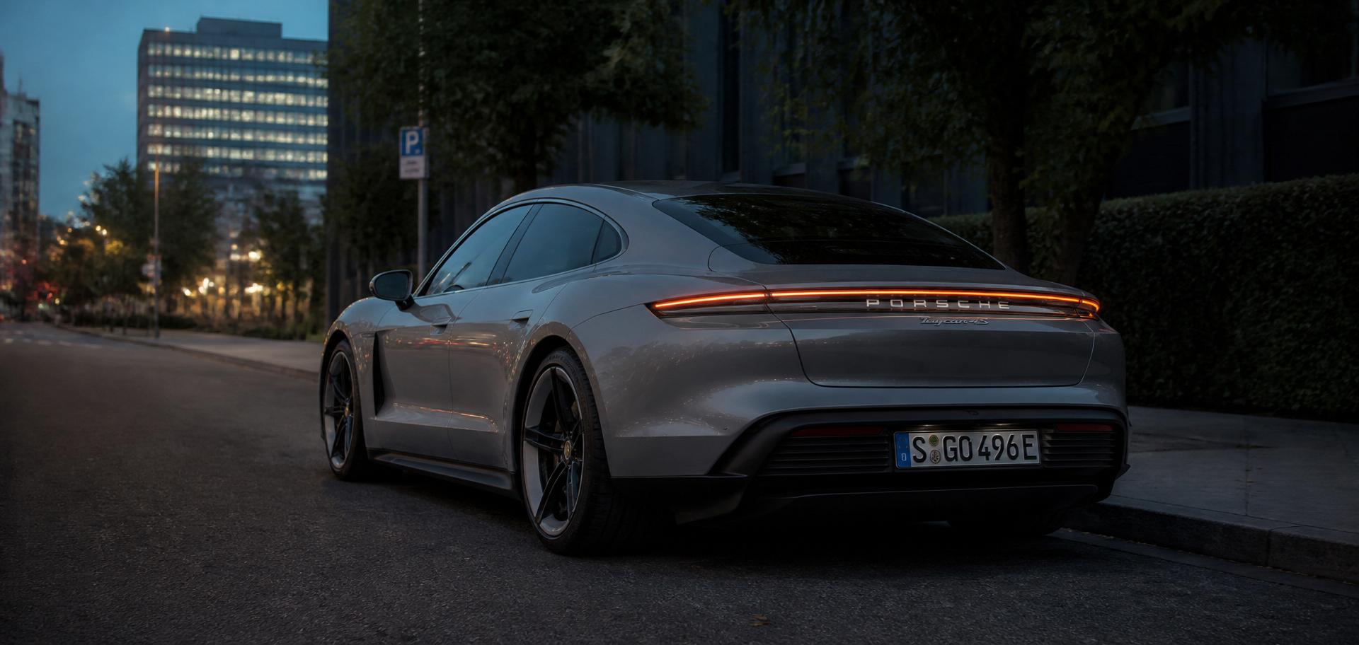 Premium electric vehicle at blue hour on a rooftop overlooking the city